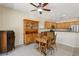 Inviting dining area with a wooden table, complemented by a view of the kitchen space at 2555 Moonlight Valley Ave, Henderson, NV 89044