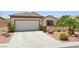 Inviting single-story home showcasing a well-maintained front yard and an attached two-car garage at 2555 Moonlight Valley Ave, Henderson, NV 89044