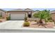 Charming single-story home with a two-car garage and meticulously landscaped front yard at 2555 Moonlight Valley Ave, Henderson, NV 89044