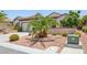 Beautiful single-story home displaying desert landscaping with a mature palm tree in the front yard at 2555 Moonlight Valley Ave, Henderson, NV 89044