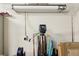 Utility equipment in garage featuring water softener, electrical outlet, lighting and storage at 2555 Moonlight Valley Ave, Henderson, NV 89044
