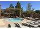 Community hot tub surrounded by lounge chairs and a covered pergola in a sunny outdoor setting at 2555 Moonlight Valley Ave, Henderson, NV 89044