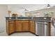 Kitchen featuring stainless steel dishwasher, wood cabinets, and an undermount sink for a sleek, modern look at 2555 Moonlight Valley Ave, Henderson, NV 89044