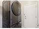 Modern, front-load, stackable Samsung washer and dryer set conveniently located near a white door at 2555 Moonlight Valley Ave, Henderson, NV 89044