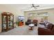 Cozy living room featuring plush seating, a ceiling fan, and large windows for ample natural light at 2555 Moonlight Valley Ave, Henderson, NV 89044