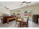 Open-concept living and dining area with comfortable seating and a view of the backyard at 2555 Moonlight Valley Ave, Henderson, NV 89044