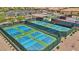 Aerial view of multiple well-maintained outdoor pickleball courts in a community setting, providing a recreational amenity at 2555 Moonlight Valley Ave, Henderson, NV 89044