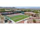 Overhead view of community tennis and bocce ball courts, surrounded by lush landscaping and scenic views at 2555 Moonlight Valley Ave, Henderson, NV 89044