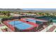 Aerial view of community tennis courts featuring well-maintained surfaces, lighting, and shade structures for comfortable play at 2555 Moonlight Valley Ave, Henderson, NV 89044