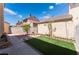 Backyard with astroturf and decorative plants and pots at 2745 Poppyseed Way, Las Vegas, NV 89142