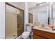 Bathroom with glass shower, oak vanity and toilet with storage space at 2745 Poppyseed Way, Las Vegas, NV 89142