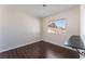 Bedroom with hardwood floors, white walls, a window and custom desk at 2745 Poppyseed Way, Las Vegas, NV 89142