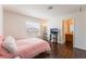 Comfortable bedroom featuring wood floors, a TV and an open bathroom at 2745 Poppyseed Way, Las Vegas, NV 89142