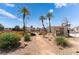 Community area with orange flowering shrubs and a seating area at 2745 Poppyseed Way, Las Vegas, NV 89142