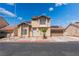 Two-story home featuring a neutral stucco exterior, two-car garage, and a small palm tree in the front yard at 2745 Poppyseed Way, Las Vegas, NV 89142