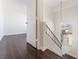 Upstairs hallway featuring wood floors, white trim and lots of natural light at 2745 Poppyseed Way, Las Vegas, NV 89142