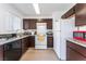 Bright kitchen features dark cabinets, light countertops, and white appliances at 2745 Poppyseed Way, Las Vegas, NV 89142