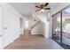 Open living room features light wood floors and a staircase with dark wood treads and metal railing at 2745 Poppyseed Way, Las Vegas, NV 89142