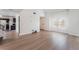 Bright living room with light wood flooring, access to the kitchen, and a view of the front door at 2745 Poppyseed Way, Las Vegas, NV 89142