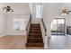 Bright foyer area with a wooden staircase and wood flooring on the first floor at 2745 Poppyseed Way, Las Vegas, NV 89142