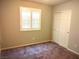 Bedroom showing a window with shutters and sliding closet doors in neutral tones at 2822 Chetco River St, Laughlin, NV 89029