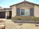 Close up of the front of a charming single-story home with desert landscaping and decorative shutters at 2822 Chetco River St, Laughlin, NV 89029
