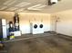 Garage area equipped with a water heater, water filtration system, and washer and dryer at 2822 Chetco River St, Laughlin, NV 89029