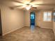 Spacious living room with ceiling fan, tile floors, and view of the front door at 2822 Chetco River St, Laughlin, NV 89029