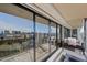 Spacious balcony with comfortable seating area and panoramic city views through sliding glass doors at 3111 Bel Air Dr # 21A & 21C, Las Vegas, NV 89109