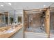 Modern bathroom features a marble vanity with a mirrored wall and a tiled shower-tub at 3111 Bel Air Dr # 21A & 21C, Las Vegas, NV 89109