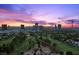 Las Vegas skyline view from above neighborhood and golf course at dusk at 3111 Bel Air Dr # 21A & 21C, Las Vegas, NV 89109
