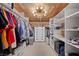 A walk-in closet with custom shelving and wood ceiling at 3111 Bel Air Dr # 21A & 21C, Las Vegas, NV 89109