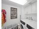 Cozy laundry room featuring washer, dryer, upper cabinets, and decorative wall art at 3111 Bel Air Dr # 21A & 21C, Las Vegas, NV 89109