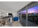 Modern condo living room featuring a granite bar and a spectacular city view at sunset at 3111 Bel Air Dr # 21A & 21C, Las Vegas, NV 89109