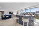 Modern condo living room featuring a stylish blue sofa and granite bar with a spectacular city view at 3111 Bel Air Dr # 21A & 21C, Las Vegas, NV 89109