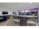 Modern condo living room featuring a stylish blue sofa, granite bar, and a spectacular city view at 3111 Bel Air Dr # 21A & 21C, Las Vegas, NV 89109