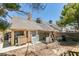 A view of the backyard with a block wall, gravel, playground equipment, and part of the roof at 3127 Kennewick Dr, Las Vegas, NV 89121