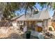View of the backyard with covered patio, yard and mature trees at 3127 Kennewick Dr, Las Vegas, NV 89121