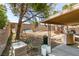 View of the backyard with block wall, covered patio, concrete, and items scattered across the yard at 3127 Kennewick Dr, Las Vegas, NV 89121