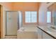 Bathroom with glass shower, tub, and single sink vanity with overhead lighting at 3127 Kennewick Dr, Las Vegas, NV 89121