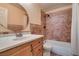 Bathroom with vanity, round mirror, and tiled shower/tub combination at 3127 Kennewick Dr, Las Vegas, NV 89121