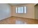 Empty bedroom featuring light laminate floors and natural light from a large window at 3127 Kennewick Dr, Las Vegas, NV 89121