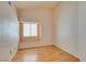 Bright bedroom with neutral walls, hardwood floors, and a window seat underneath the window at 3127 Kennewick Dr, Las Vegas, NV 89121