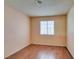 Cozy bedroom with wood laminate flooring and a window that provides natural light at 3127 Kennewick Dr, Las Vegas, NV 89121