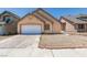 View of the home's front exterior featuring an attached garage and low maintenance landscaping at 3127 Kennewick Dr, Las Vegas, NV 89121