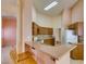 Kitchen with breakfast bar featuring wood cabinets and updated countertops at 3127 Kennewick Dr, Las Vegas, NV 89121