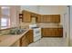 Well-lit kitchen with a gas range, tile countertops and classic wood cabinets at 3127 Kennewick Dr, Las Vegas, NV 89121