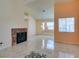 Spacious living room with fireplace, large window, and tile flooring at 3127 Kennewick Dr, Las Vegas, NV 89121