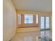 Cozy living room featuring large windows, a built-in bench, and tiled flooring at 3127 Kennewick Dr, Las Vegas, NV 89121