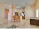 Open-concept living space featuring a breakfast bar, tiled floors, and natural light at 3127 Kennewick Dr, Las Vegas, NV 89121